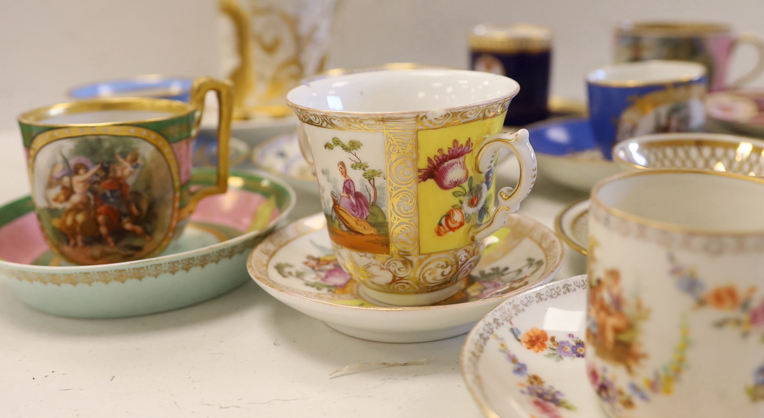 A collection of European cabinet cups and saucers, including a gilded Berlin cup and saucer (12)